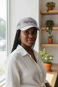 Black woman wearing Redamancy trucker hat with amethyst typography